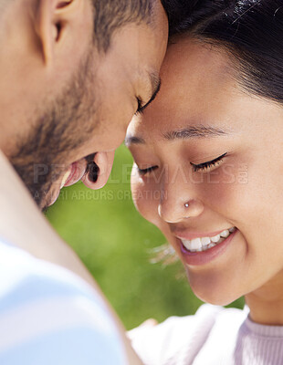 Buy stock photo Shot of a young couple spending time together in the garden at home