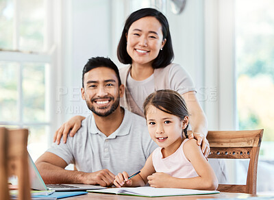Buy stock photo Shot of young parent helping their daughter with homework at home