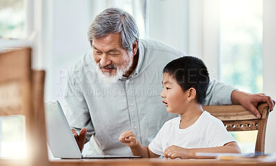 Buy stock photo Shot of a grandfather helping his grandchild with his homework at home