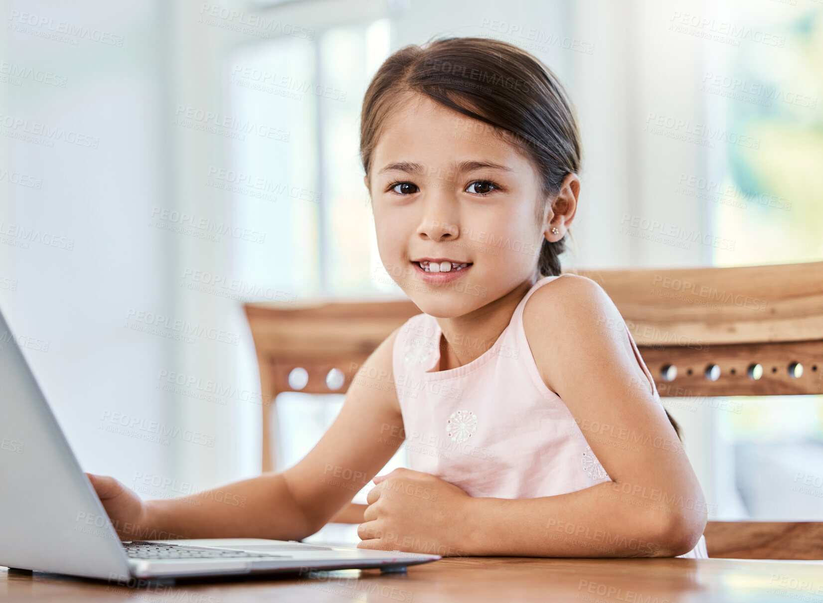 Buy stock photo Shot of a little girl using a laptop at home