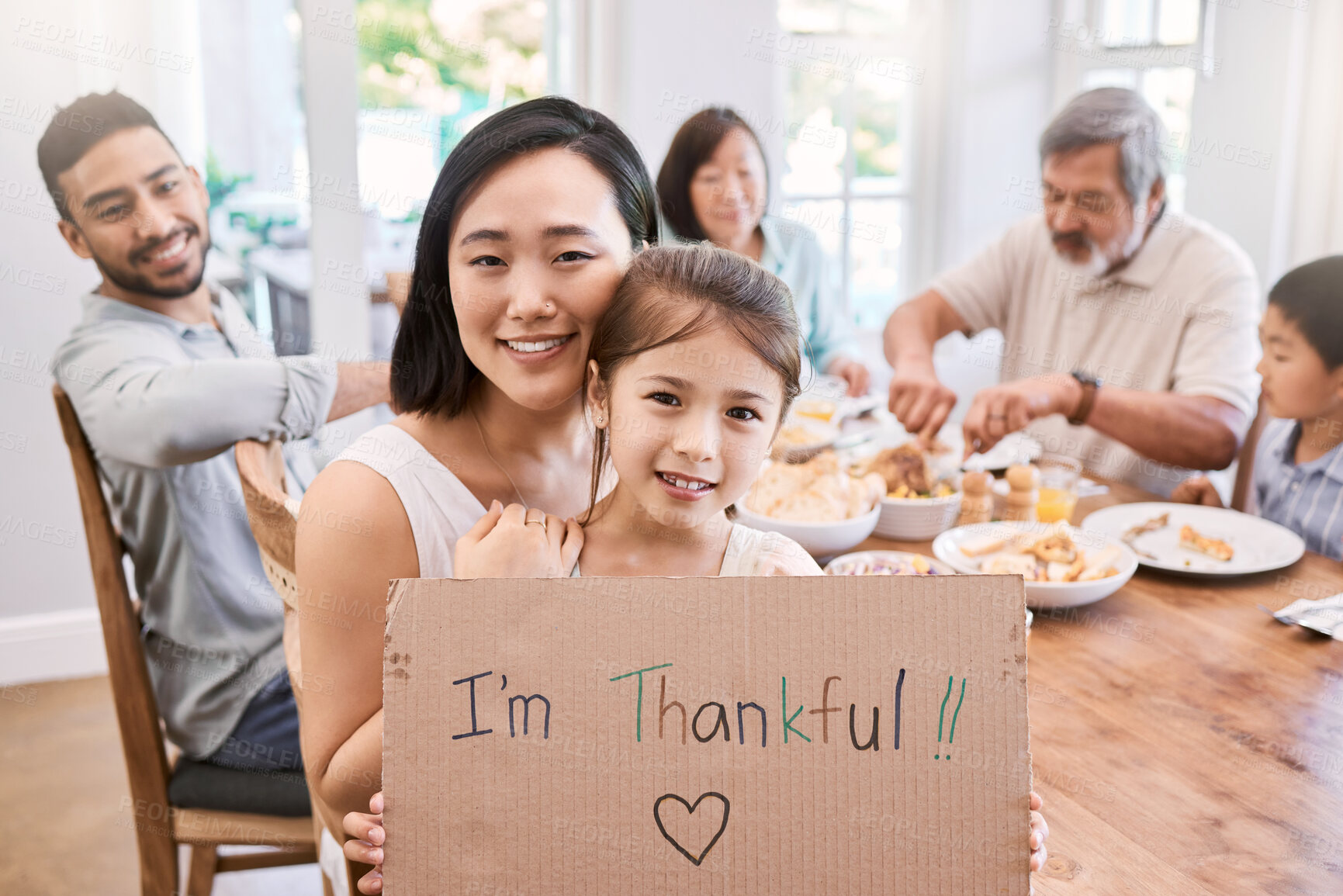 Buy stock photo Shot of a little girl holding a sign while having lunch at home
