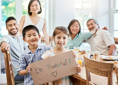 Buy stock photo Shot of a little girl holding a sign while having lunch at home