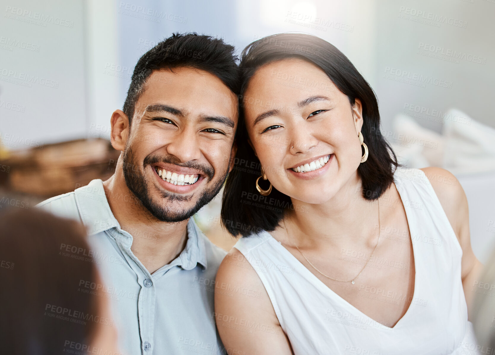 Buy stock photo Shot of a young couple have some lunch with the family at home