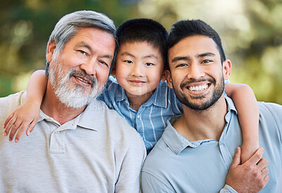 Buy stock photo Shot of an adorable little boy spending a fun day in the park with his father and grandfather