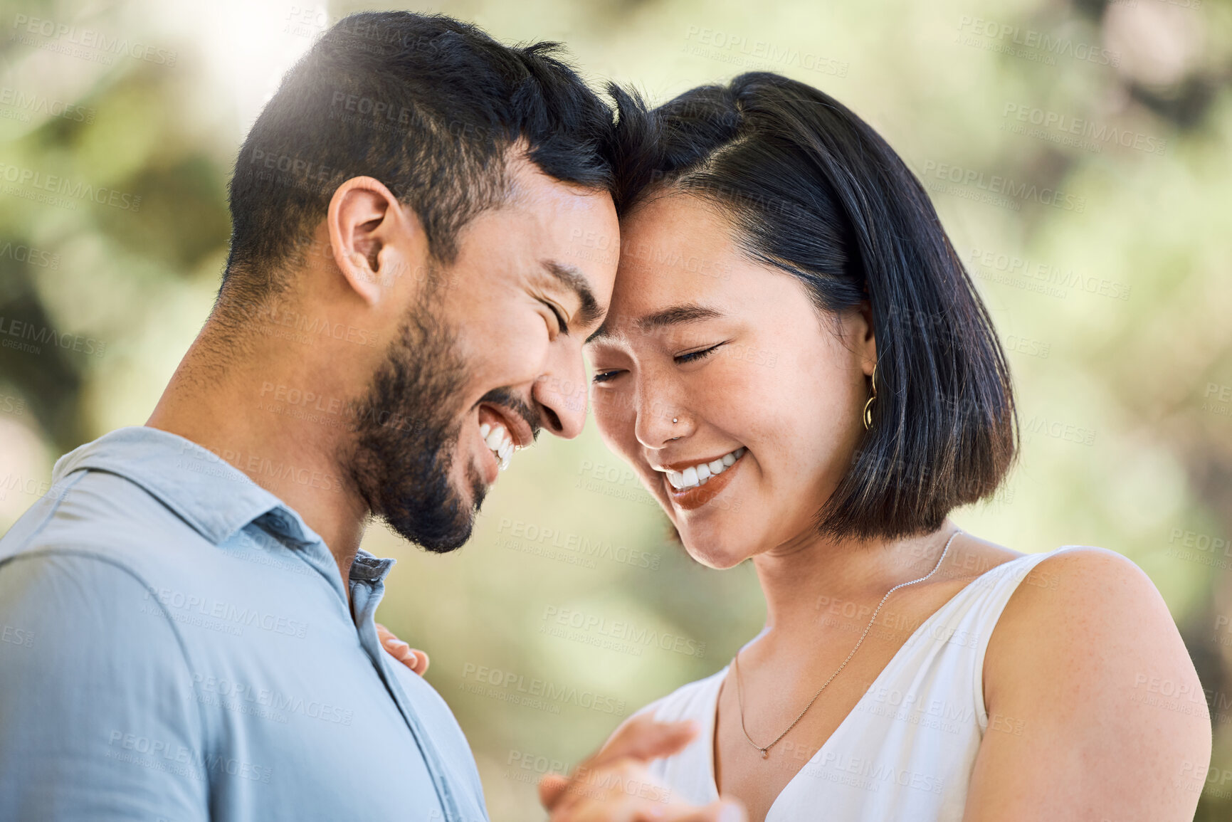 Buy stock photo Shot of a happy young couple dancing in a garden