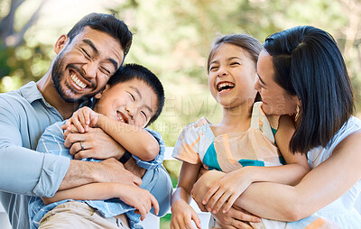 Buy stock photo Shot of a happy young family having a fun day in the park