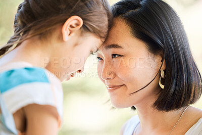 Buy stock photo Shot of an adorable little girl and her mother looking at each other face to face in a garden