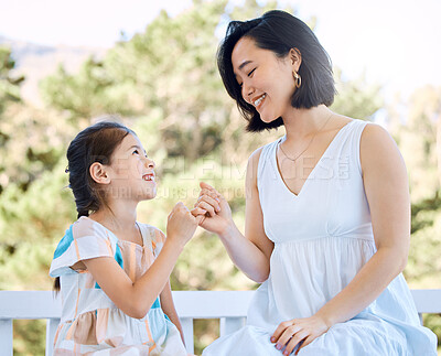 Buy stock photo Shot of an adorable little girl playing pink swear with her mother in a garden