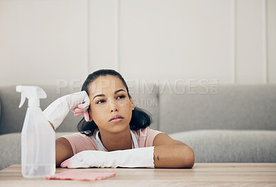 Buy stock photo Mental health, woman thinking and busy cleaning in her living room of her home. Burnout or tired, housekeeping or health wellness and female person clean for hygiene at her house with detergents