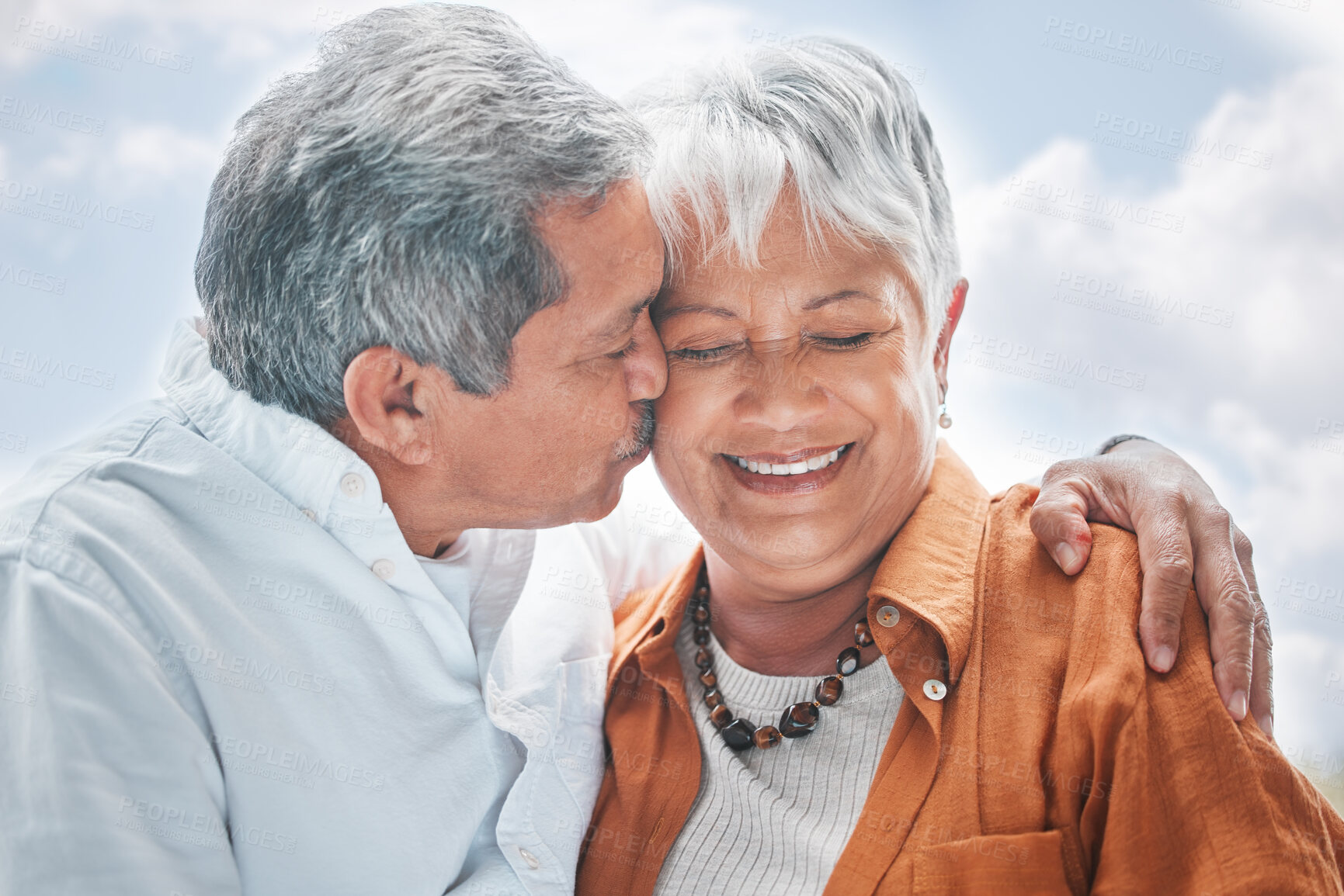 Buy stock photo Elderly couple, kiss and hug in nature for love, romance and celebrating milestone with travel. Senior people, marriage and affection outdoor for healthy relationship, commitment and trust in support