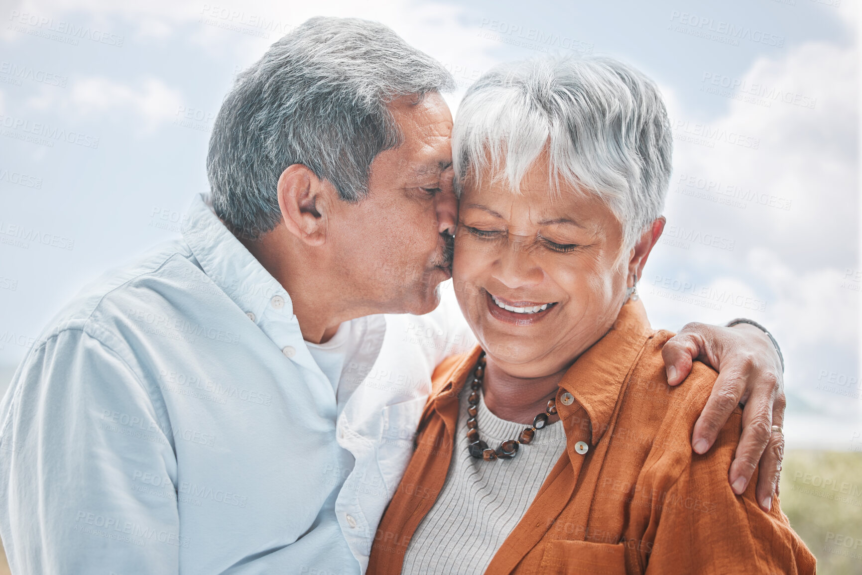 Buy stock photo Love, kiss and senior couple in nature with hug, romance or celebrating milestone with travel. Elderly people, marriage and affection outdoor for healthy relationship, commitment and trust in support