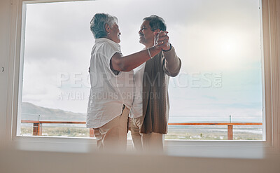 Buy stock photo Shot of a senior couple dancing together at home