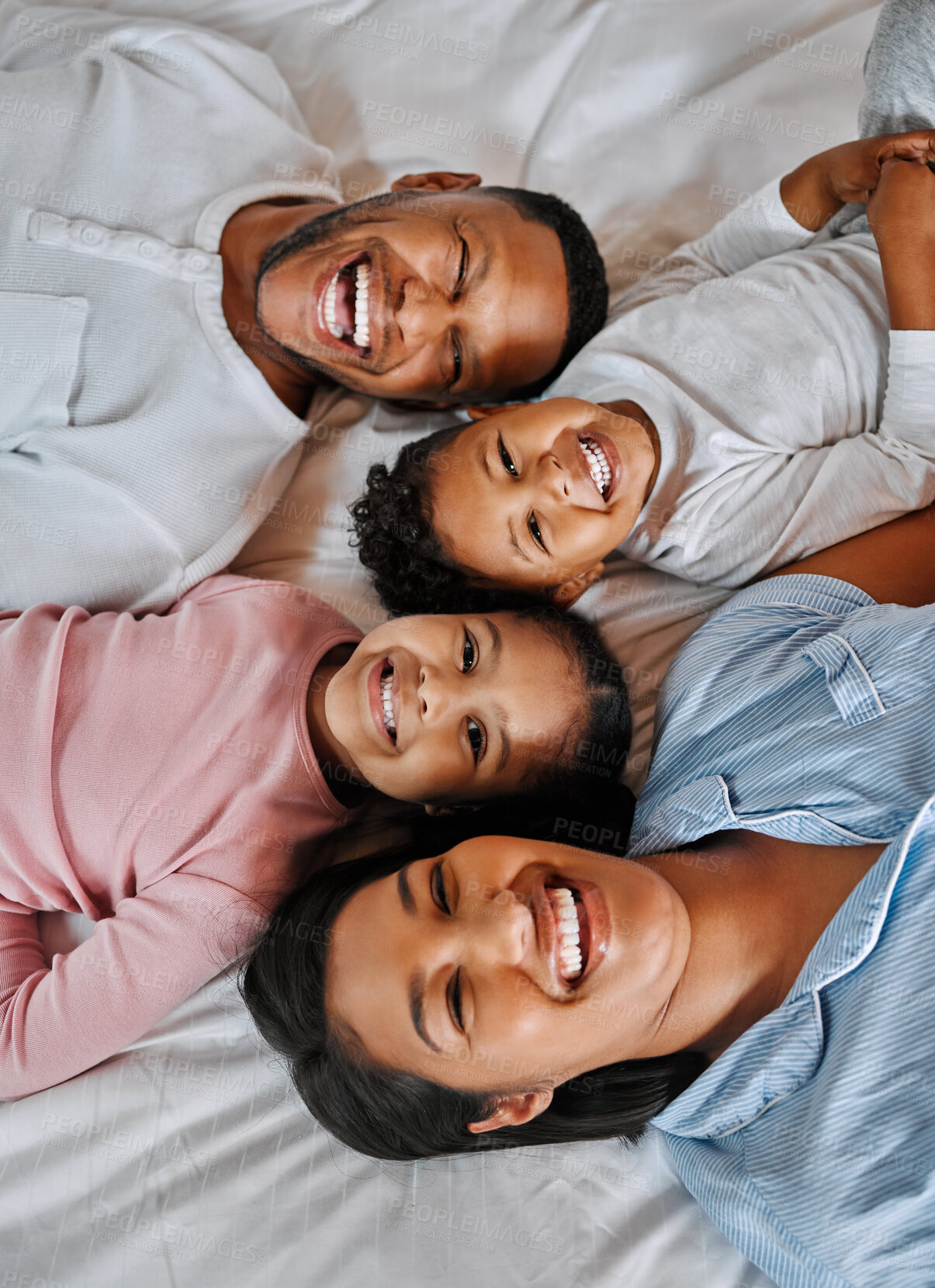 Buy stock photo Mom, dad and kids in portrait on bed with smile, love and relax in morning together from above. Mother, father and children bonding in bedroom with happy family, fun and care on weekend in home