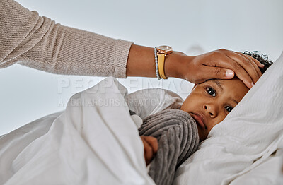 Buy stock photo Shot of an unrecognizable mother feeling her sick child's forehead at home