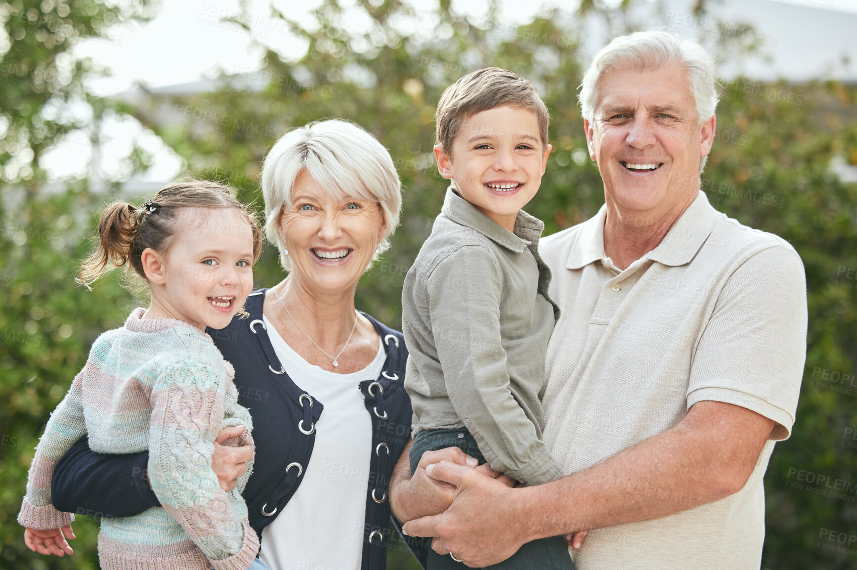 Buy stock photo Shot of a senior couple spending time outdoors with their two grandchildren