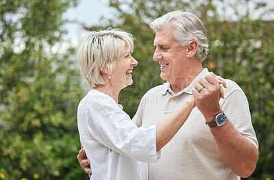 Buy stock photo Shot of a senior couple sharing a dance while standing outside