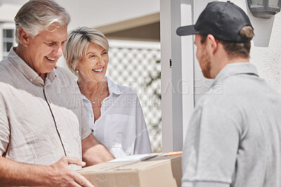 Buy stock photo Cropped shot of a handsome young male courier delivering a package to a senior couple at their home