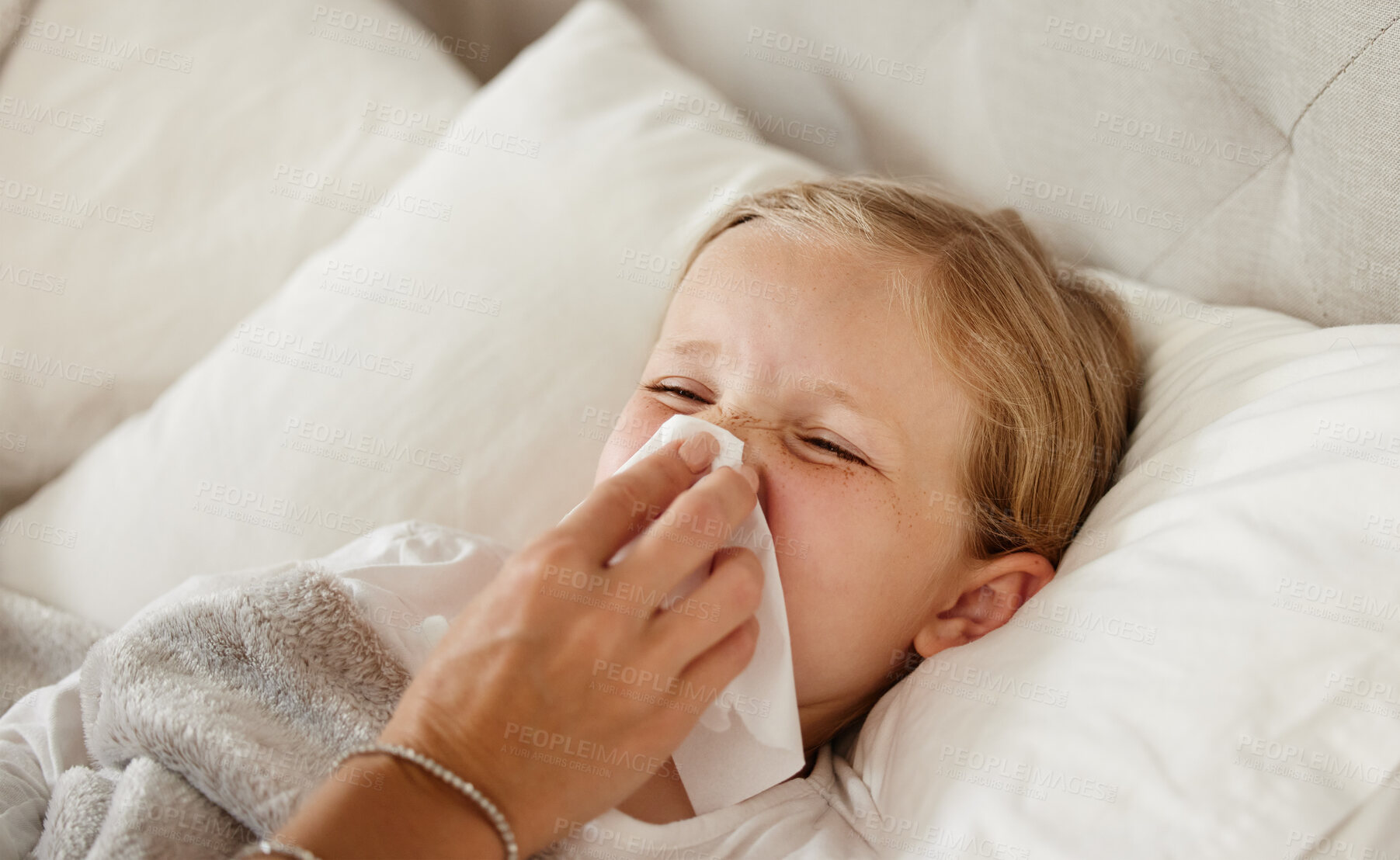 Buy stock photo Sick, child and parent blowing nose in bed for wellness, cold treatment or allergies in home. Health, person and girl with tissue for flu, virus or infection in bedroom with care, comfort and support