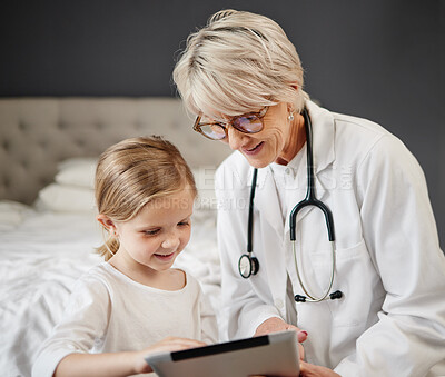 Buy stock photo Shot of a girl and a doctor using a tablet at home