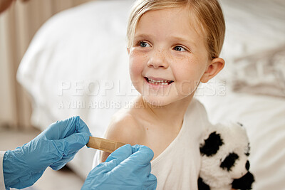 Buy stock photo Shot of an unrecognizable doctor applying a cotton ball to a patient's arm at home