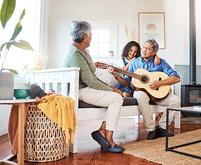 Buy stock photo Shot of a grandfather playing guitar for his grandchild at home