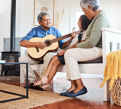 Buy stock photo Shot of a grandfather playing guitar for his grandchild at home