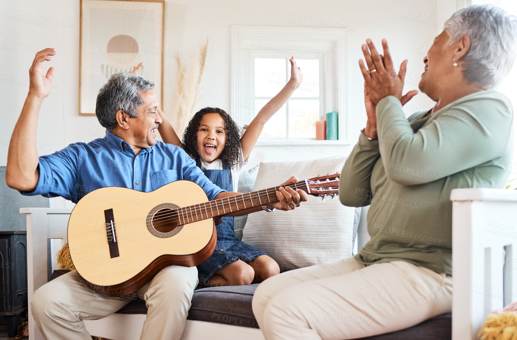 Buy stock photo Shot of a grandfather playing guitar for his grandchild at home