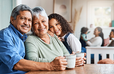 Buy stock photo Shot of a grandchild spending time with her grandparents at home