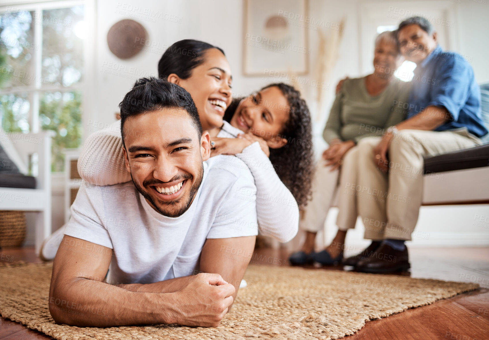 Buy stock photo Shot of a young family spending time together at home