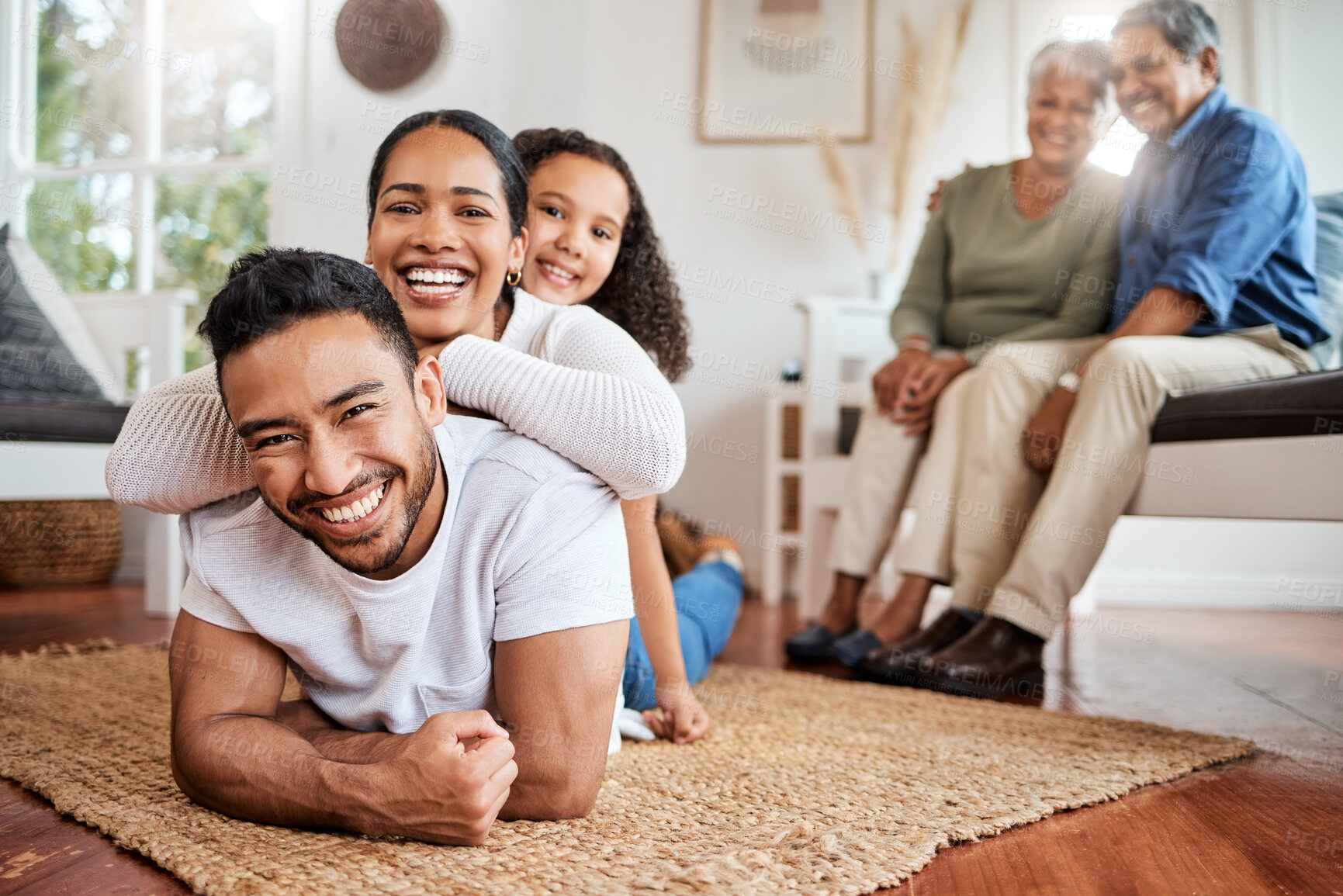 Buy stock photo Shot of a young family spending time together at home