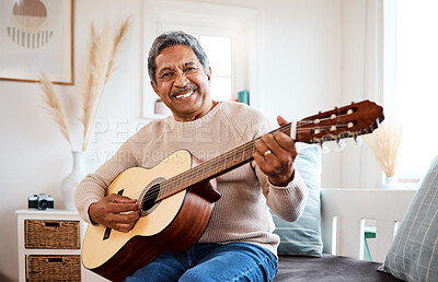 Buy stock photo Shot of a senior man playing the guitar at home