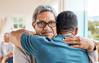 Buy stock photo Shot of a father and son hugging at home