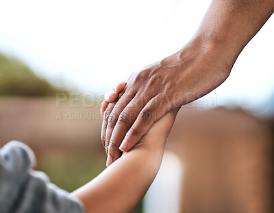 Buy stock photo Shot of an unrecognizable parent and child holding hands at home