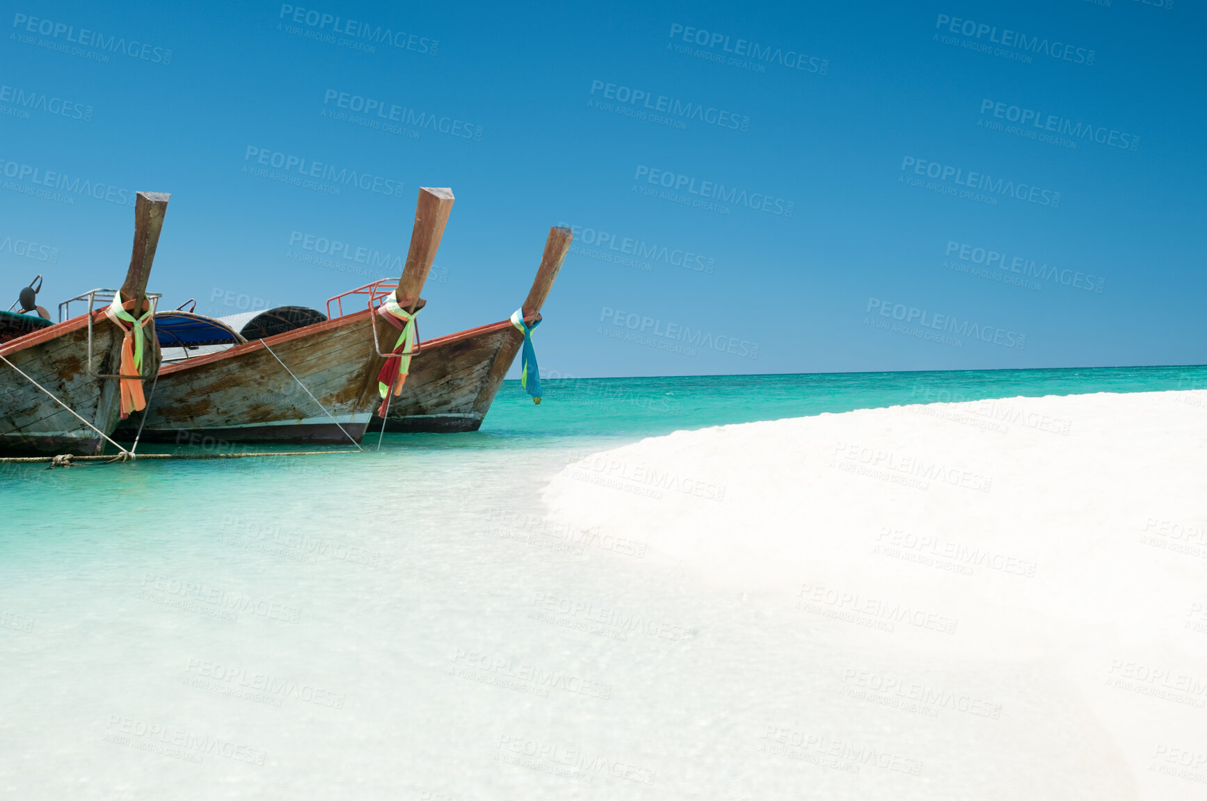 Buy stock photo Ocean, blue sky and sand on beach with boat on shore, travel and tourism with holiday destination landscape. Transport, vessel and tropical island for adventure, nature outdoor and trip to Thailand