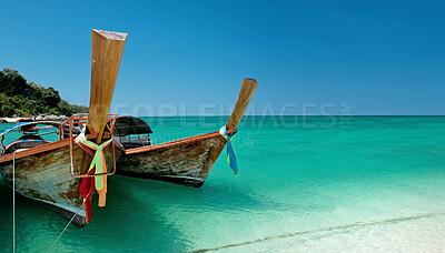 Buy stock photo Ocean, blue sky and sun on beach with boat on shore, travel and tourism with holiday destination landscape. Transport, vessel and tropical island for adventure, nature outdoor and trip to Thailand