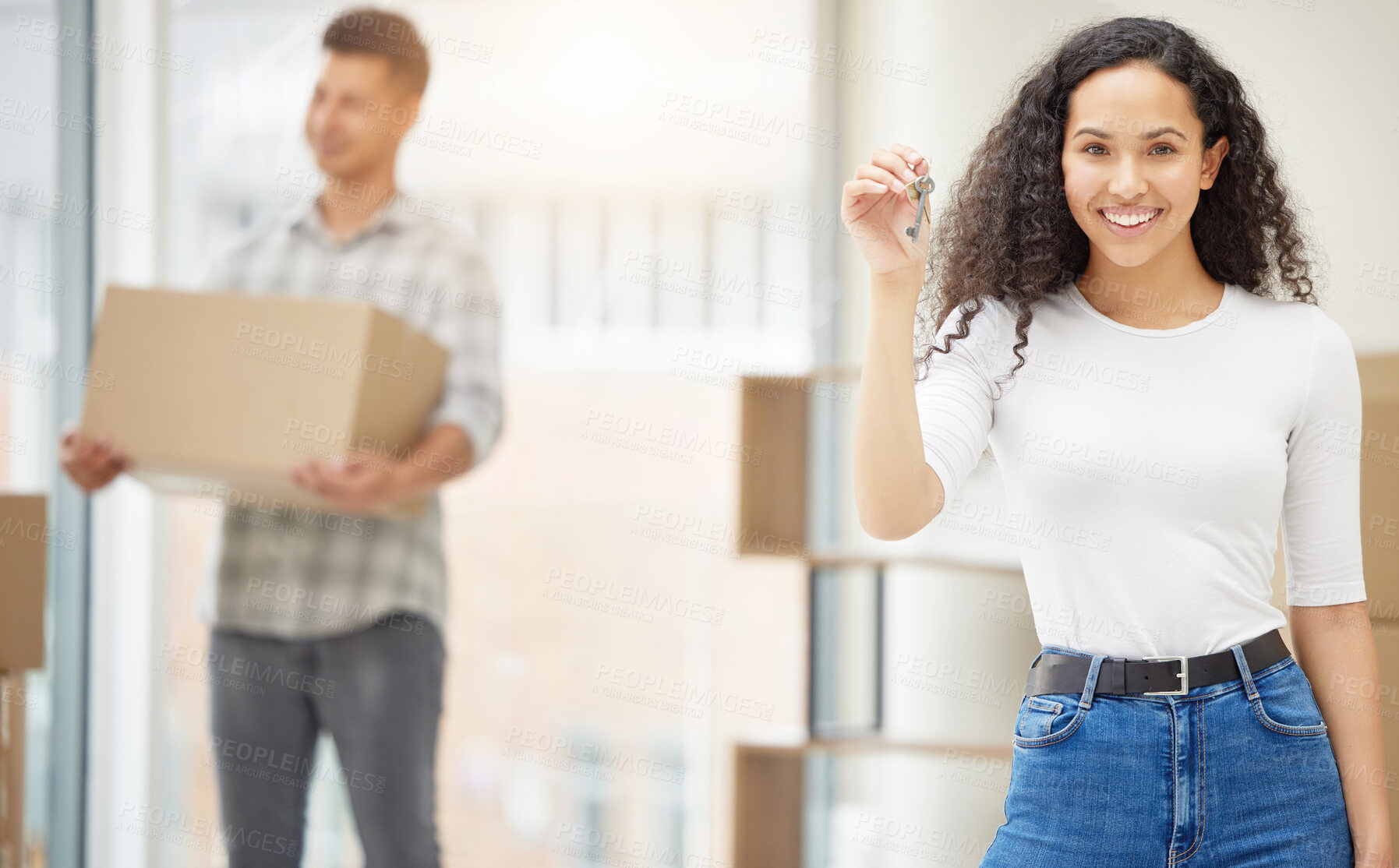 Buy stock photo Shot of a young couple moving into their new home