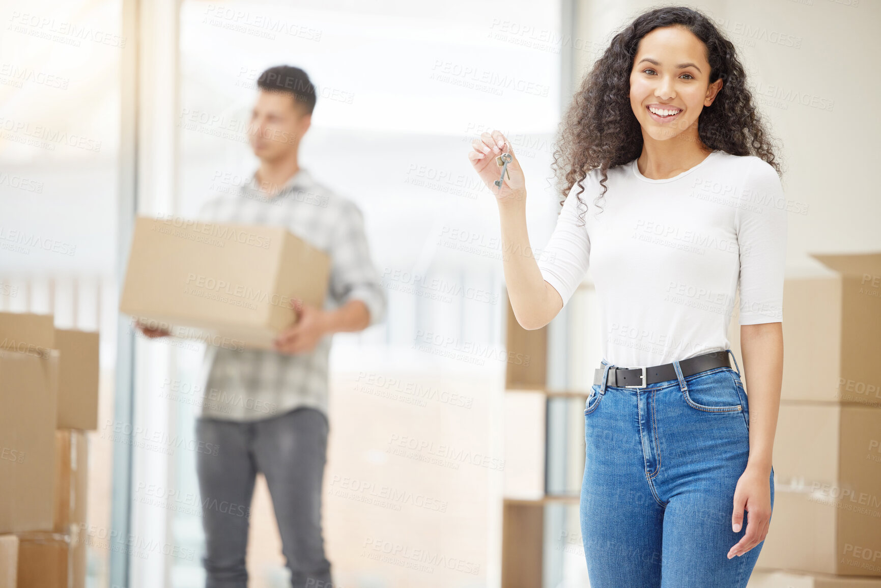 Buy stock photo Shot of a young couple moving into their new home