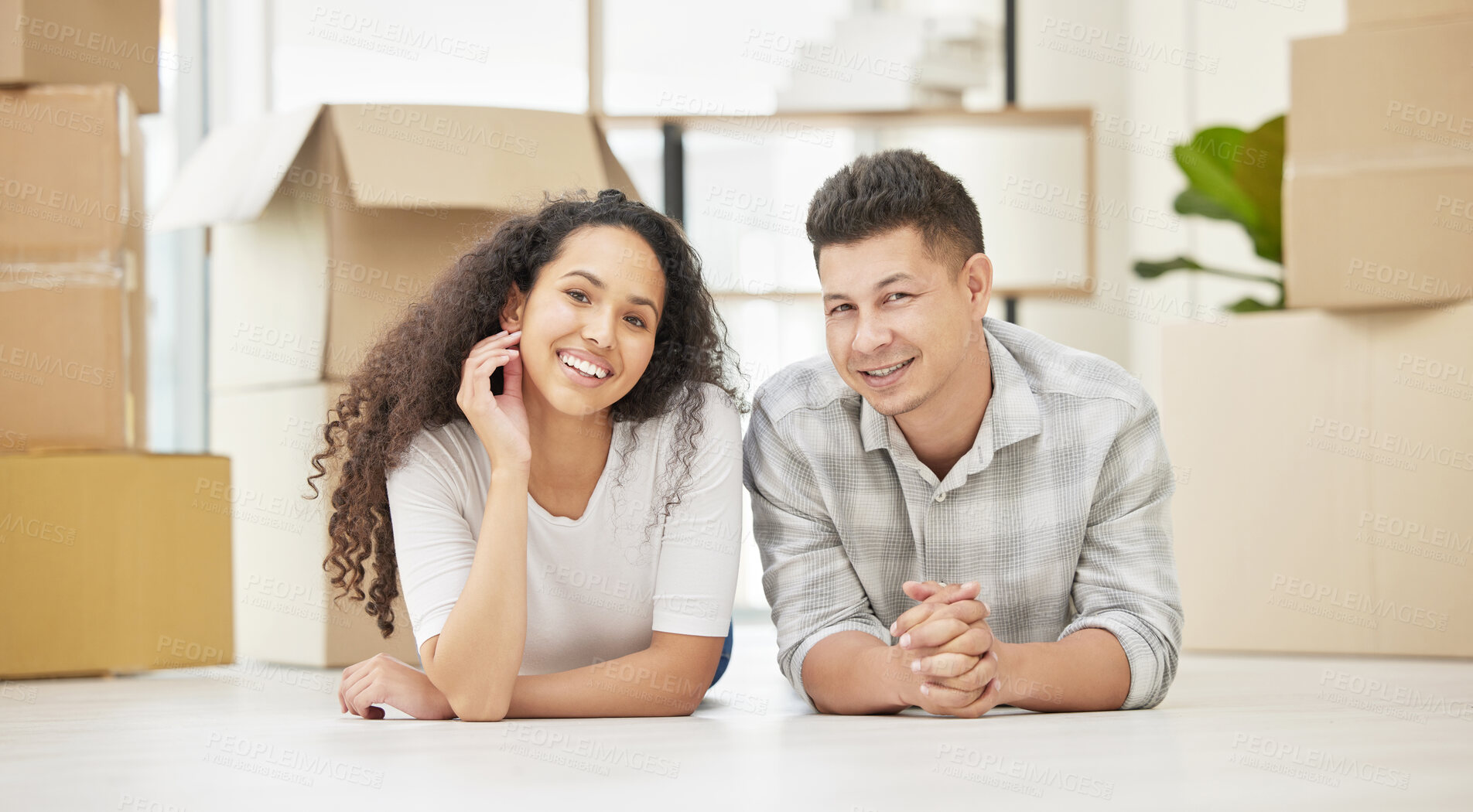 Buy stock photo New home, box and portrait of couple on floor with smile for mortgage, investment and relocation. Happy, man and woman with cardboard package on ground for property, moving and commitment in marriage