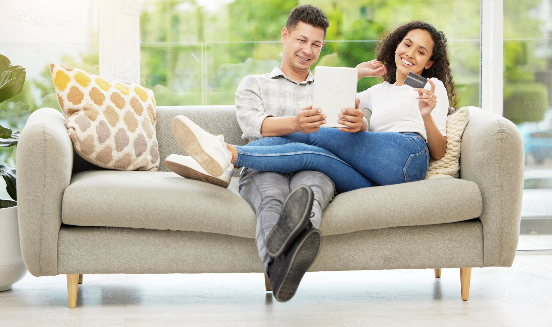 Buy stock photo Tablet, credit card and couple on sofa in living room for mortgage, debt or property investment payment. Happy, relax and people with digital technology for internet bank with online shopping at home