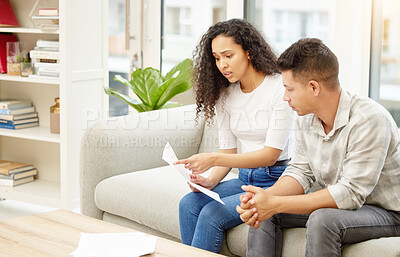 Buy stock photo Shot of a young couple looking stressed while holding an eviction notice