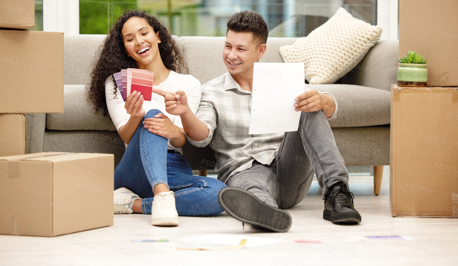 Buy stock photo Shot of a young couple deciding on a new colour for their home