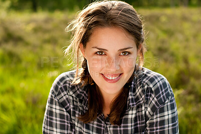 Buy stock photo Woman, portrait and smile in grass field for spring with happiness, flowers and wellness. Female gen z person, rest and fresh air with relax by countryside for weather, farm environment and sunshine