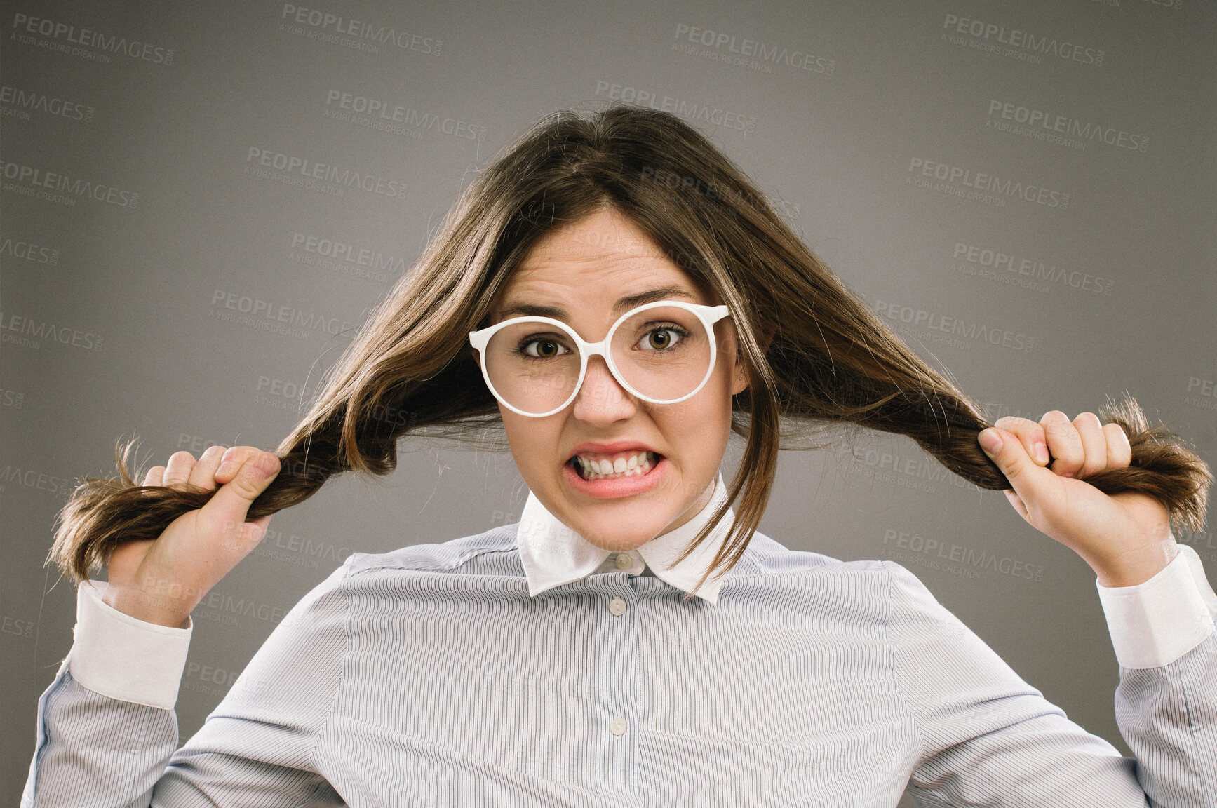 Buy stock photo Woman, portrait and pulling hair in studio with stress for education, exam or assessment by background. Girl, college student or frustrated person with anxiety for study, test or glasses for learning