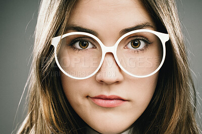 Buy stock photo Confused, glasses and portrait of girl nerd in studio on gray background for accessories or fashion. Face, doubt and vision with cute geek thinking closeup in eyewear for retro or vintage style