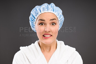 Buy stock photo Confused, portrait and woman with shower cap for bathing, cleaning and hygiene isolated on dark background. Question, funny and face of student in water proof hat for wellness by studio backdrop