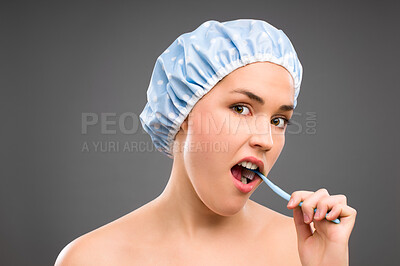 Buy stock photo Woman, brushing teeth and studio portrait for hygiene, health and cleaning for bacteria by gray background. Girl, person or model with toothbrush, dental care or wellness for mouth in morning routine