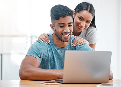 Buy stock photo Couple, laptop and Indian man in a home with online shopping and ecommerce app with wife support. Mockup, young people and happiness from promotion email in a house at desk with woman supporting