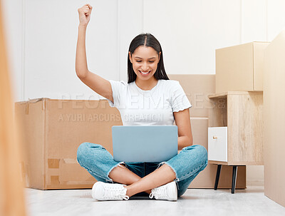 Buy stock photo Full length shot of a young woman sitting in her new home and celebrating a success while using her laptop