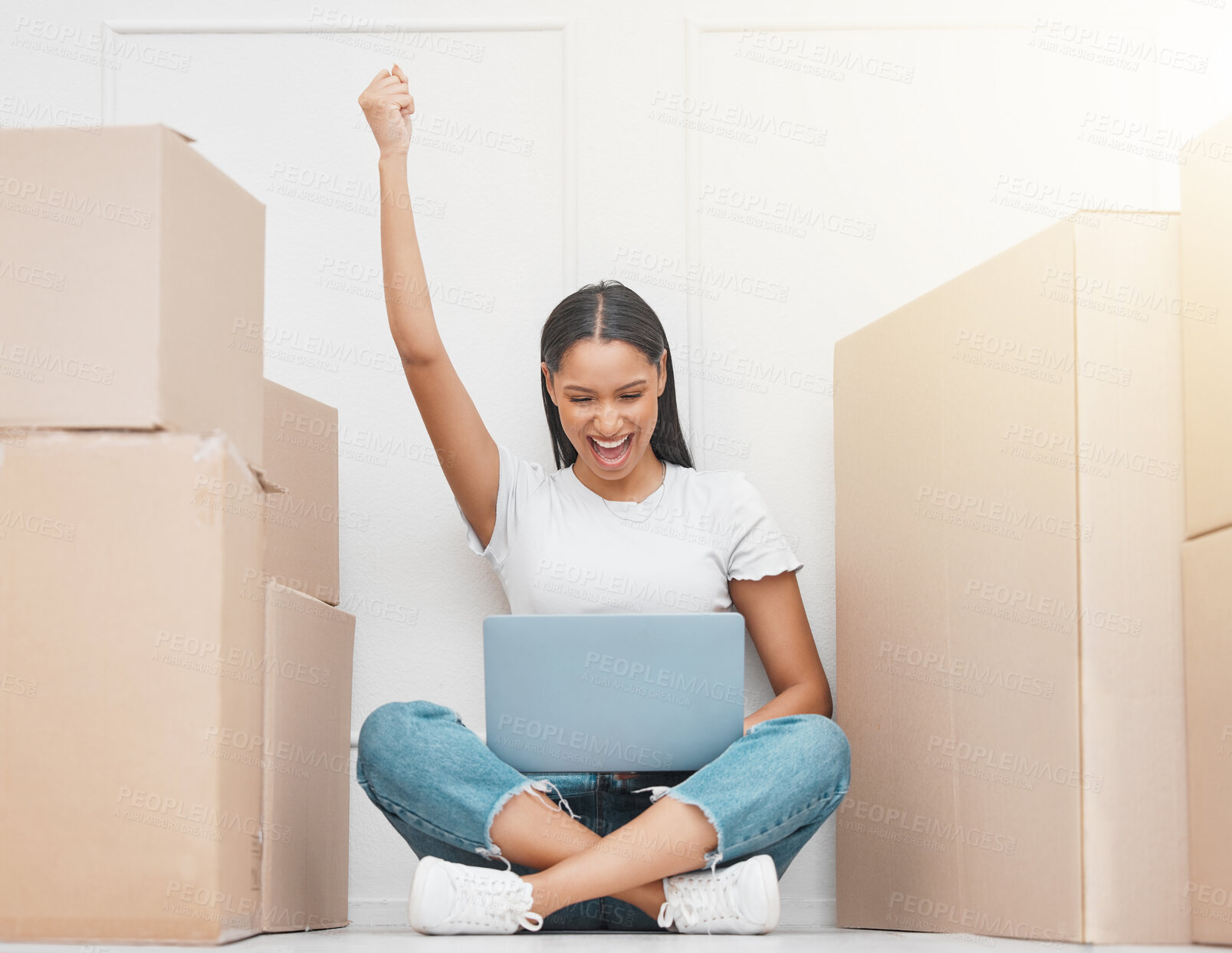 Buy stock photo Laptop, moving or woman packing with fist up and boxes in new home for celebration or real estate shopping. Smile , female person and technology for internet research and realtor communication