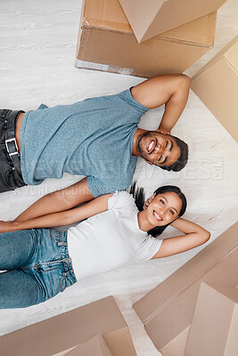 Buy stock photo Top view, home and couple with boxes, apartment and excited on the floor, mortgage and relationship. Portrait, man and woman on the ground, cardboard and excited with new house, moving in and growth